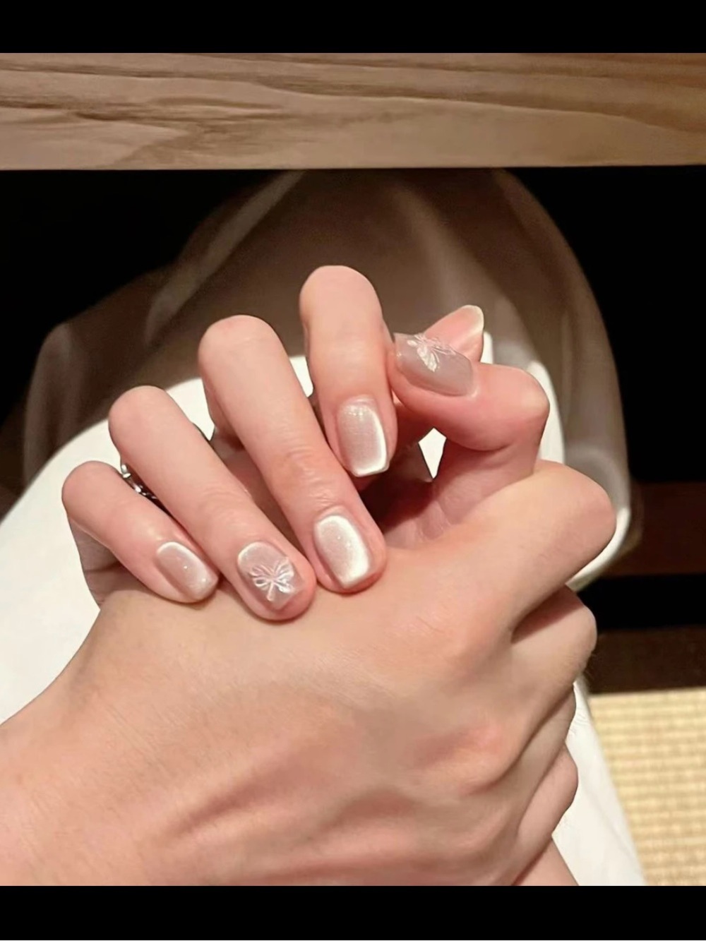 Pearlescent White Nail Polish with Subtle Bow Accent
